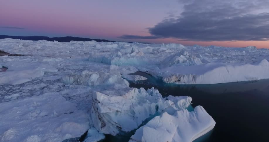 Arctic iceberg under a dark cloudy sky