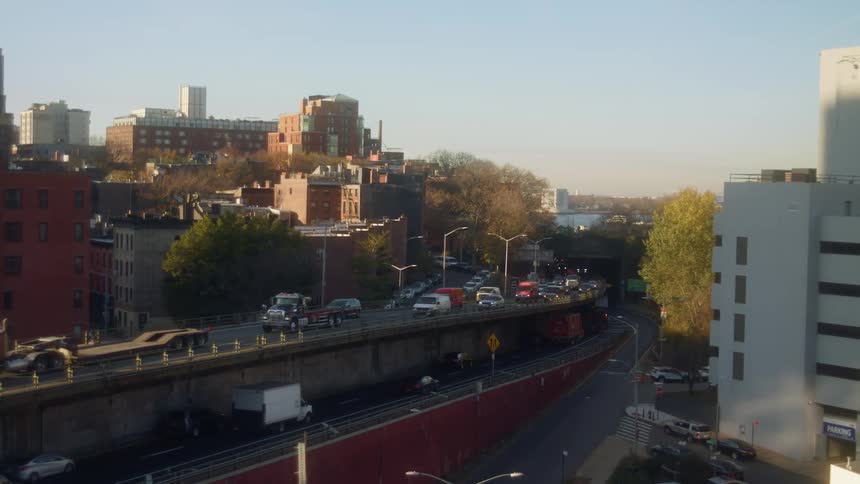 Cars traveling on a busy city street in the daytime