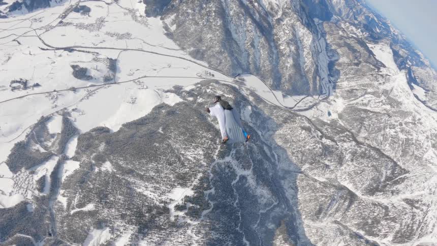 A man is wind riding over the mountain range