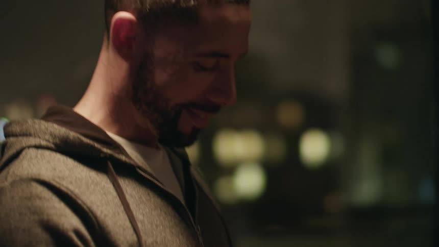 A dad smiles and bends to kiss his daughter on the forehead as she gazes up at him