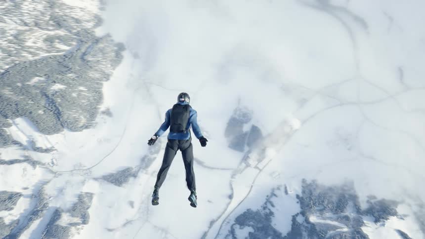 Aerial footage of a skydiver falling over the snow covered mountains