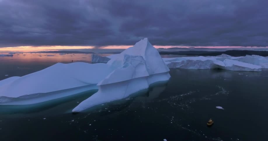 Arctic iceberg under a dark cloudy sky
