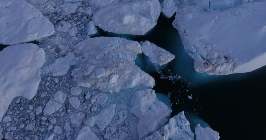 An aerial view of snow and ice floating in freezing water