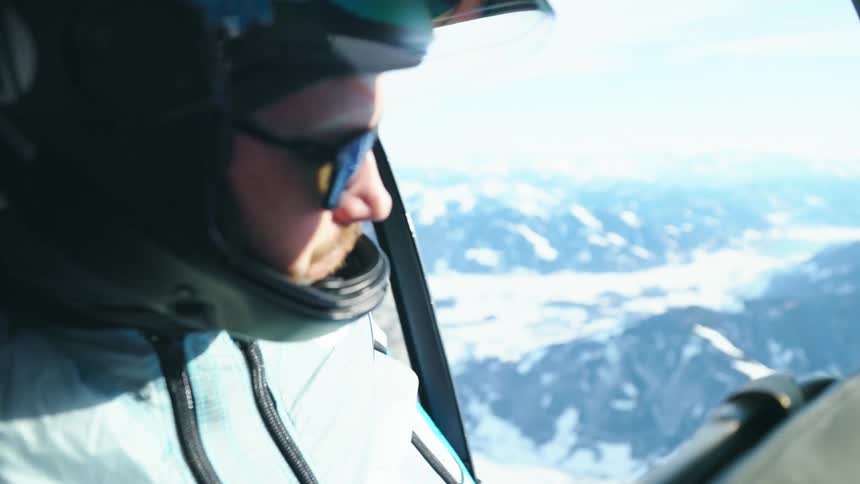 A man opens the helicopter door mid flight