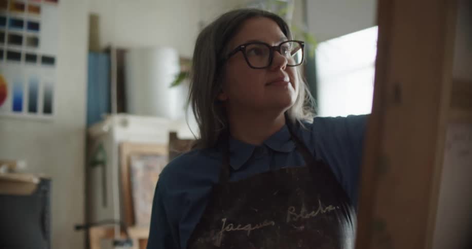 A woman is painting in the studio