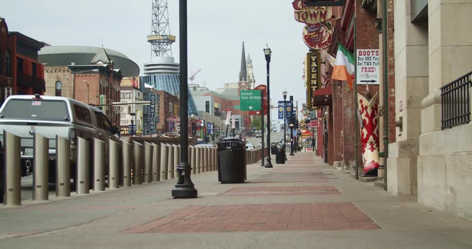 The sidewalk is empty of pedestrians in a downtown business district