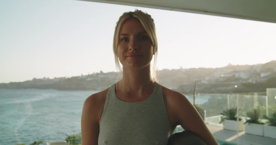 A woman staring at the camera holding a ball