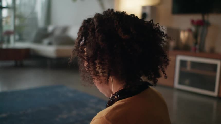 A child listening to music on the floor wearing headphones