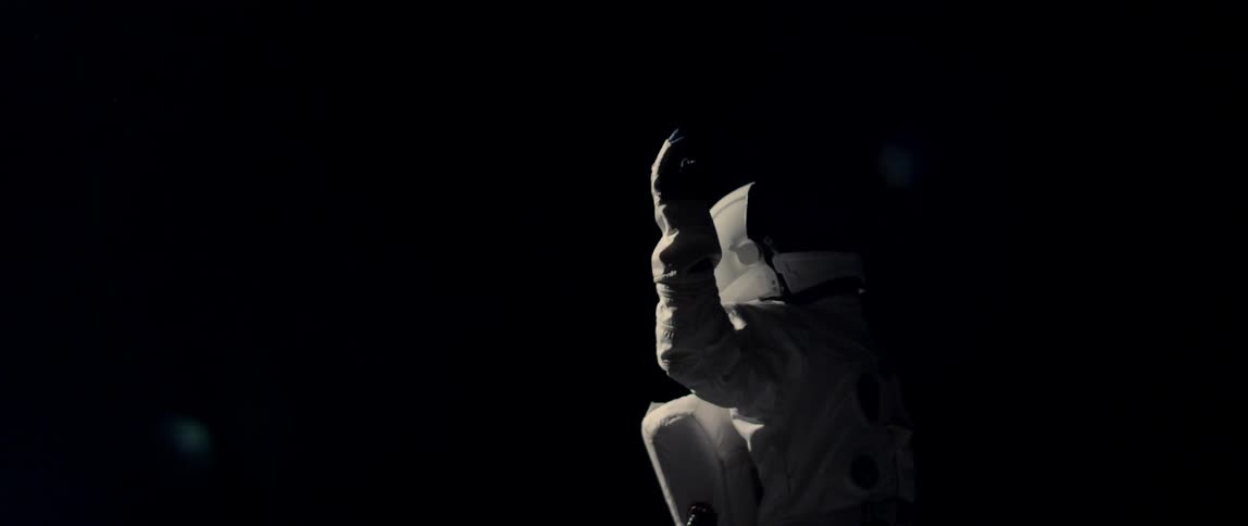 A spaceman twirls around in outer space