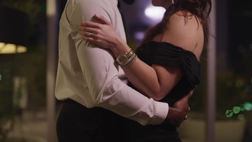 A couple dance together at night