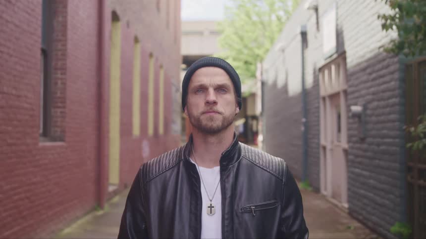 A man walking down an alley