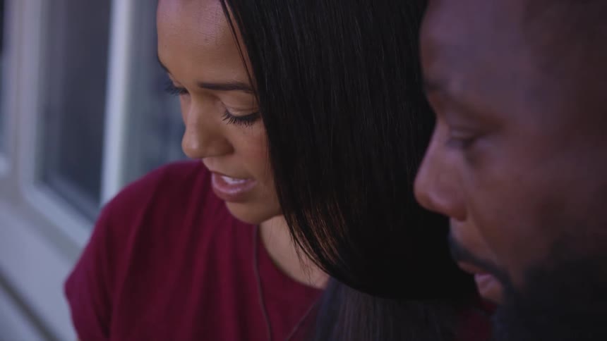 Close up of a man and woman at home talking