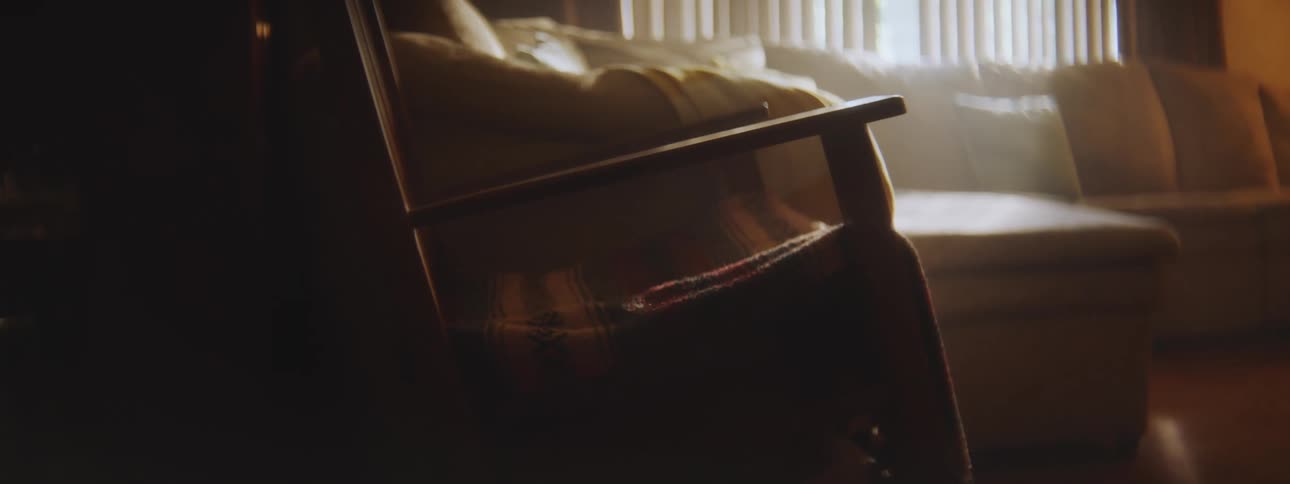 A wood rocking chair in a living room