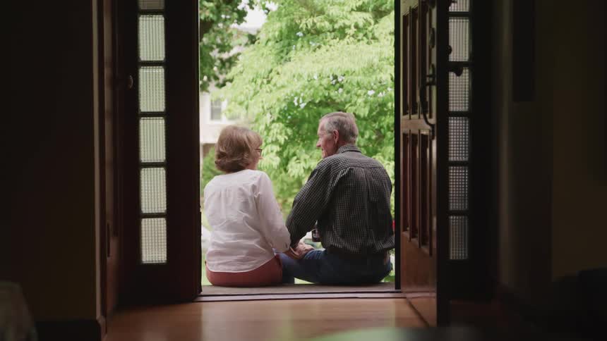 A couple sit on the stoop together