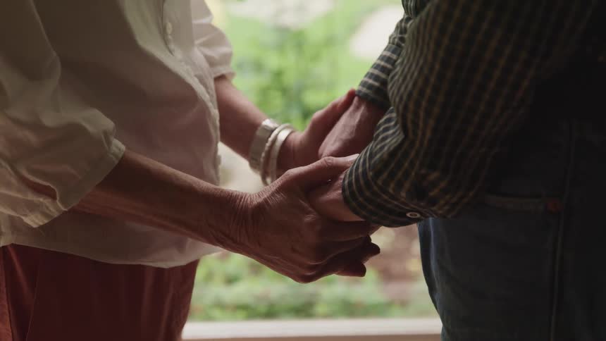 A couple are holding hands