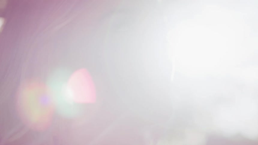 Sunlight shining on a blonde womans face outside on a summer day