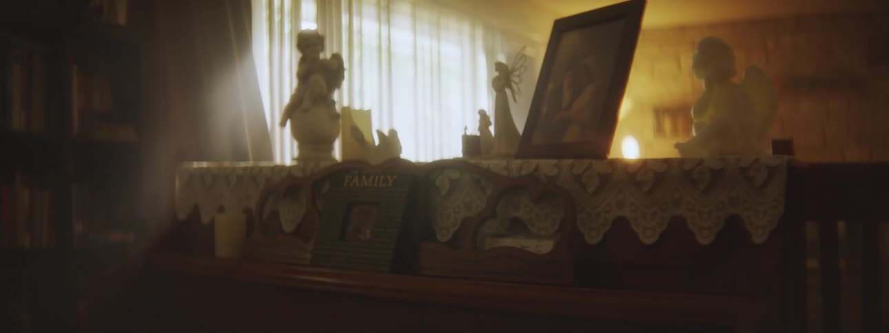 A view of statues and a portrait on a shelf
