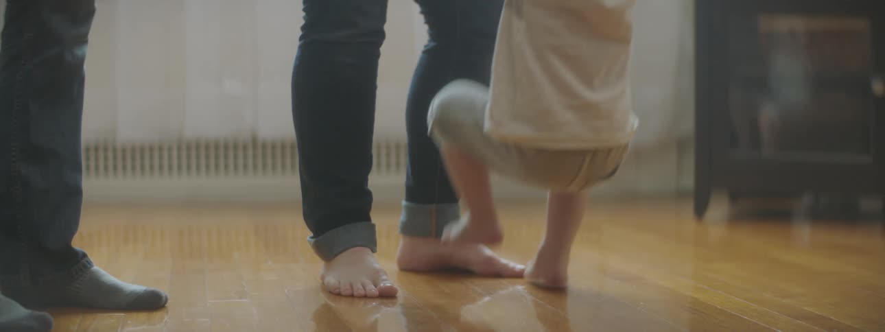 Father lifting child in apartment