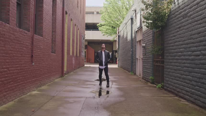 A man walking down an alley