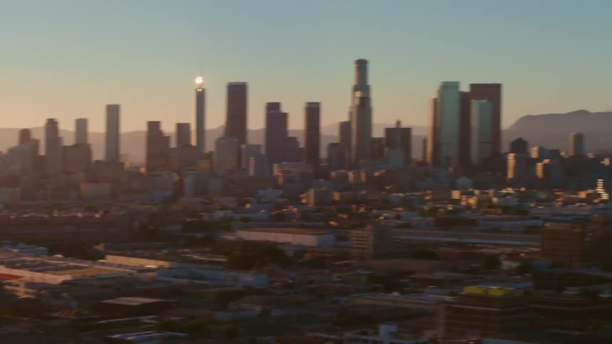 Tall buildings line the city at sunrise