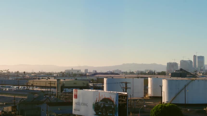 An aerial view of a factory and buildings with trucks parked outside