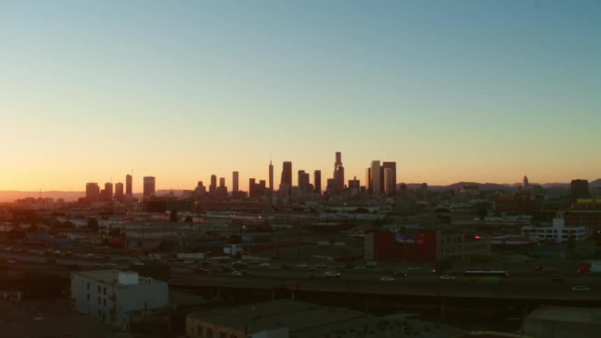 Aerial view of a downtown city at dusk is displayed