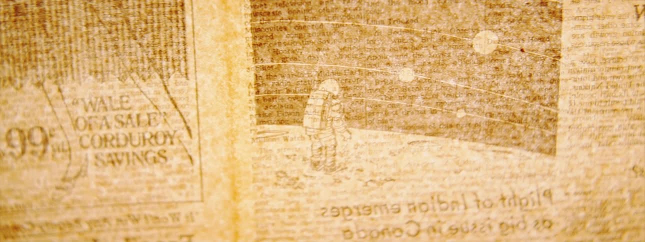 Newspaper placed over a backlighted surface inside a dimly lit room