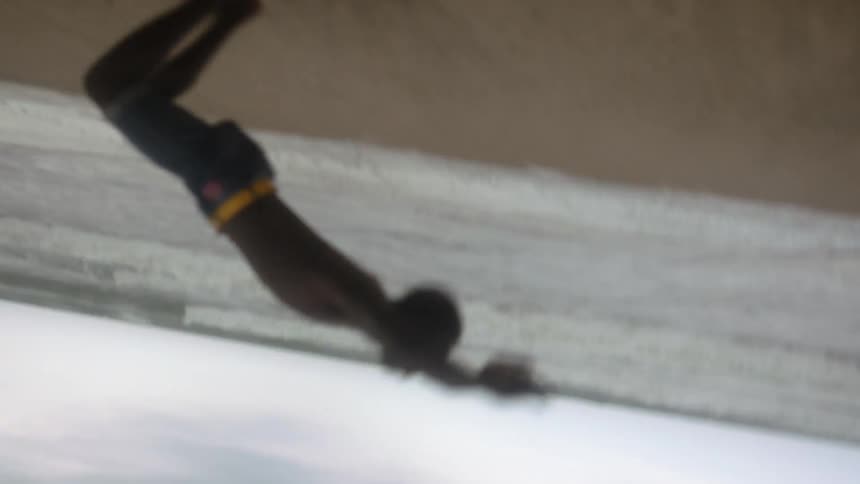 A teenage boy does handsprings on the beach