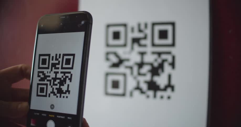 Person Scans QR Code on Phone (QR Code Used is example, Unlinked to anything)