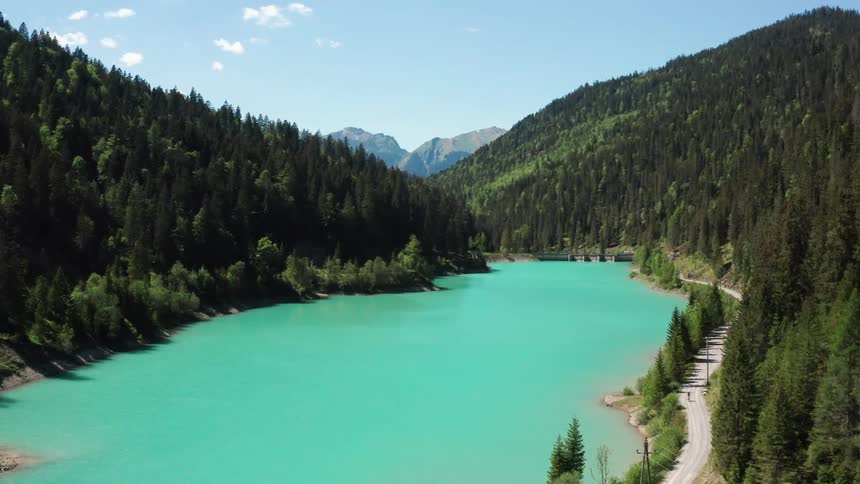 River vale with forested mountains on each side and a mountain in the distance
