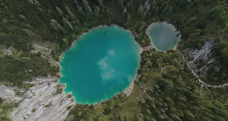 An aerial view of two lakes in a forest