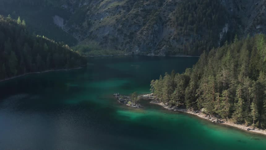 A lake with water surrounded by trees