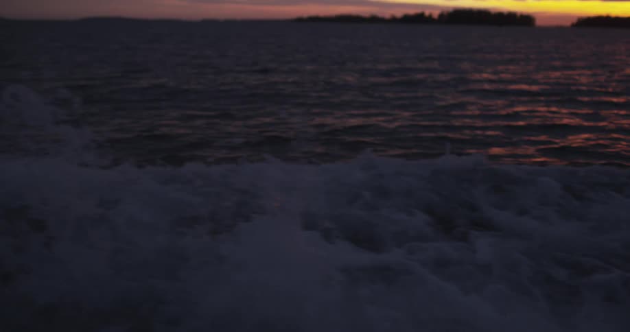 Waves move over a lake at sunset