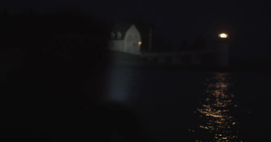 A shadow near water at night