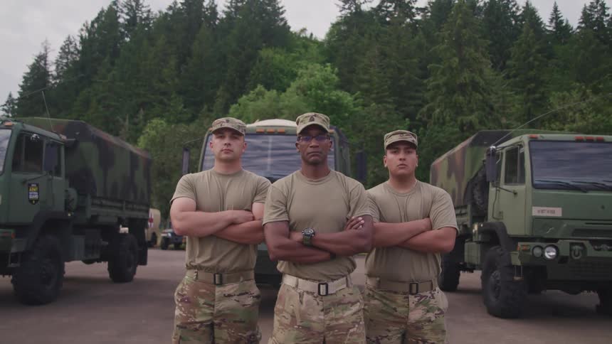 Three military people staring into the distance