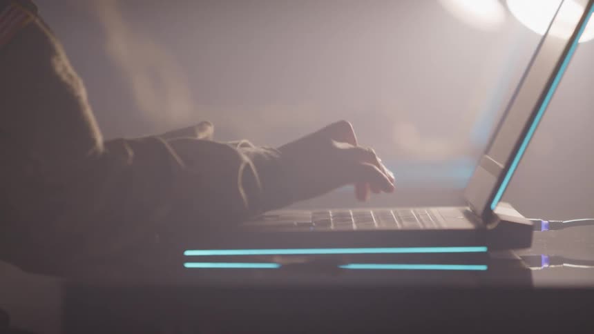 Person is typing on the keyboard of a laptop computer