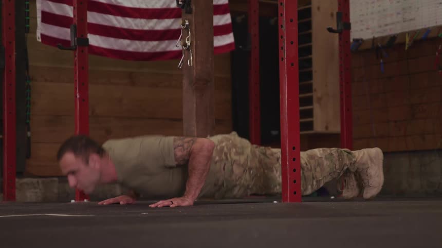 A military man is exercising indoors