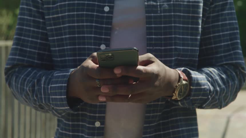 A man is using his cellphone outside