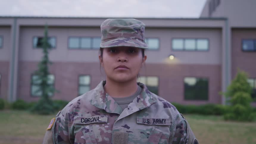 A soldier is standing outside of the building