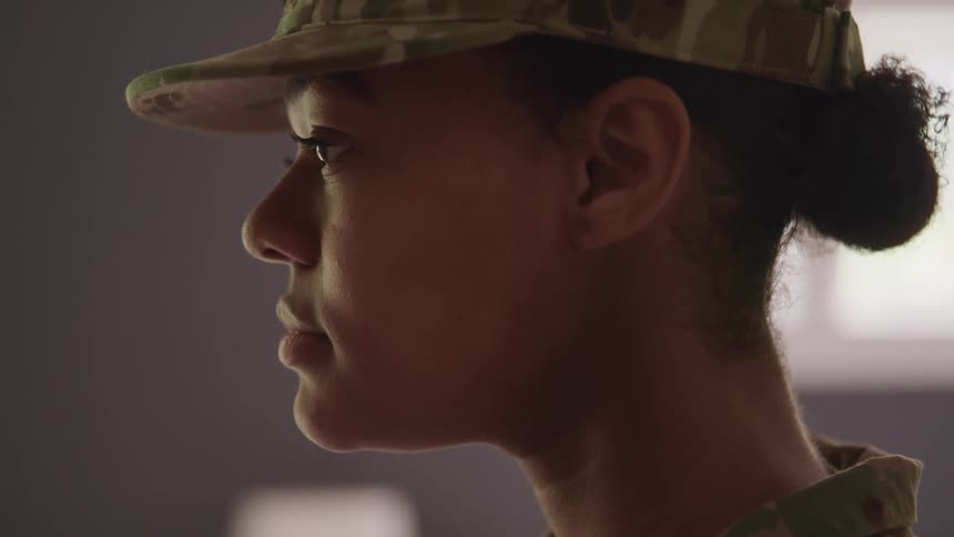 A female soldier lifts her head