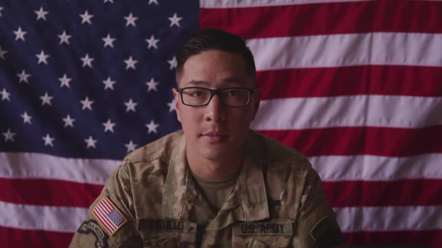A portrait of a soldier in front of a flag