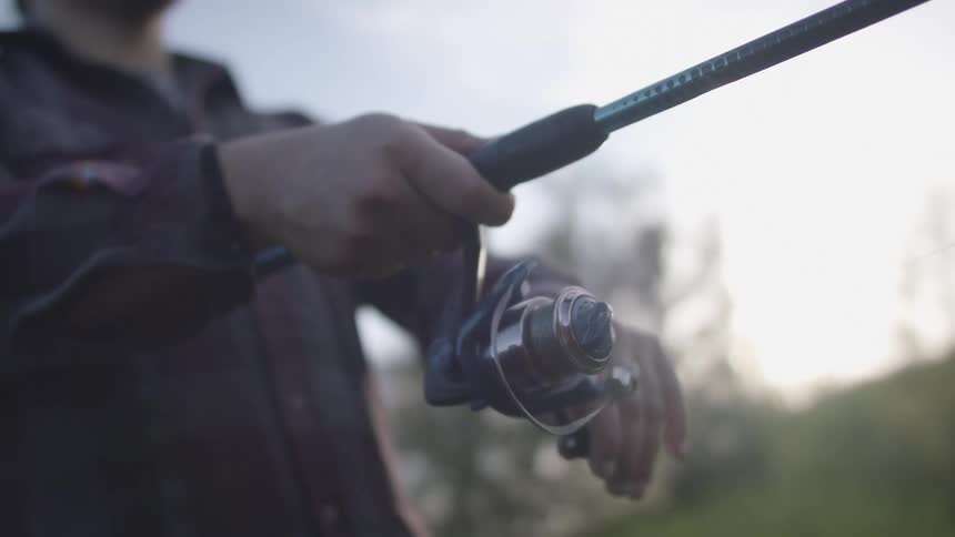 A person is fishing on a cloudy day