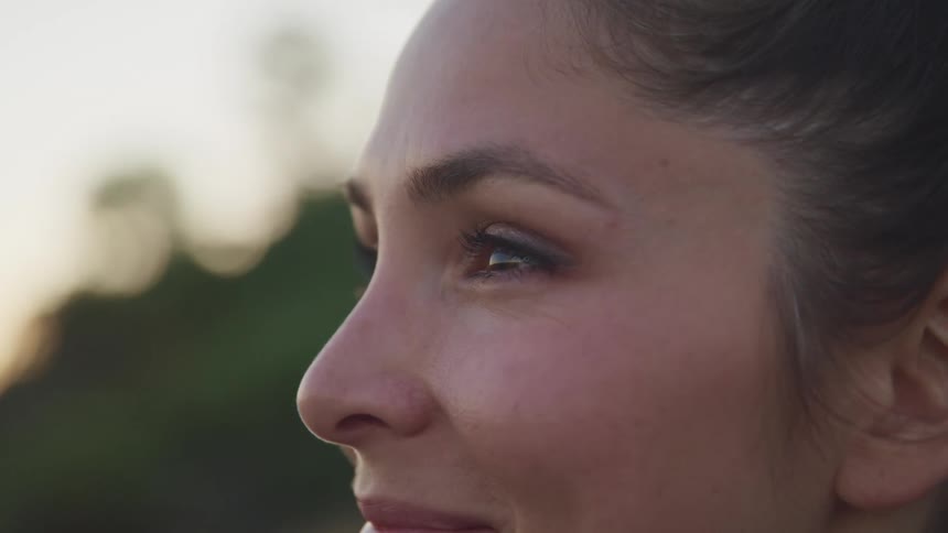 A woman is smiling outside