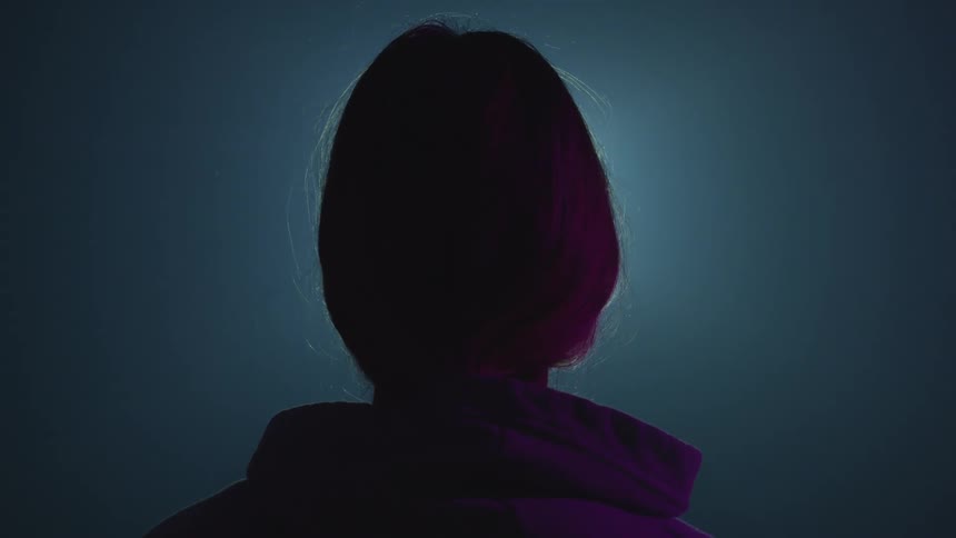 A person is standing in a room with flashing lights