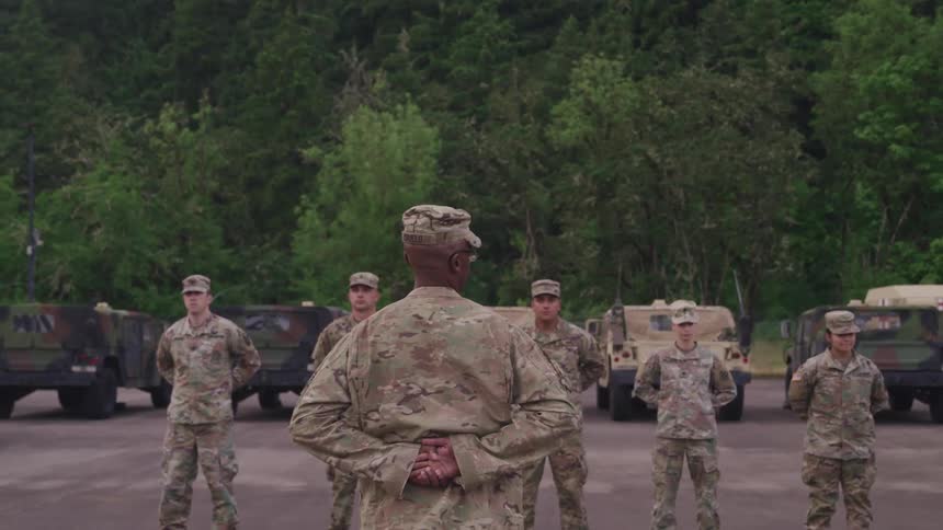 Soldiers stand at ease together