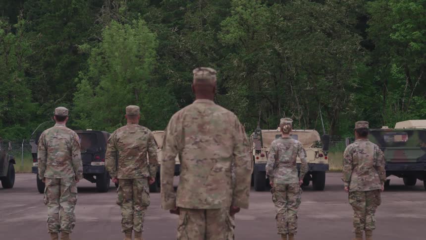Soldiers stand in front of their officer and follow commands