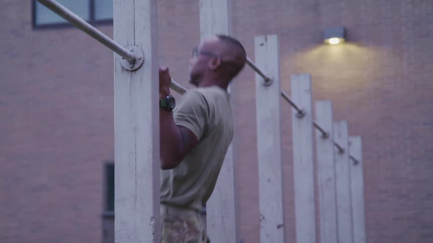 Soldier exercising in the yard close to a building at daytime
