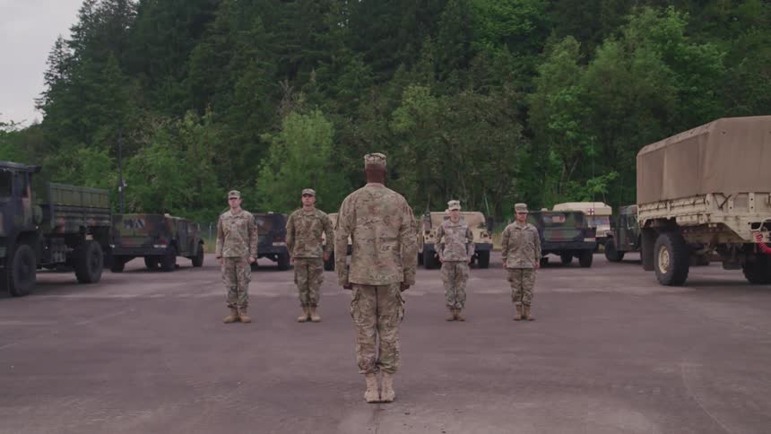 A group of soldiers salute one another