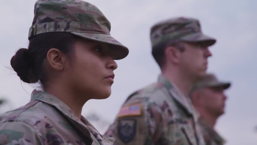Us soldiers in camouflage uniforms lined up outside