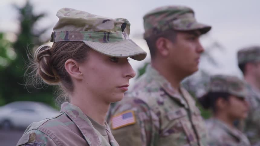 A group of people in the military saluting